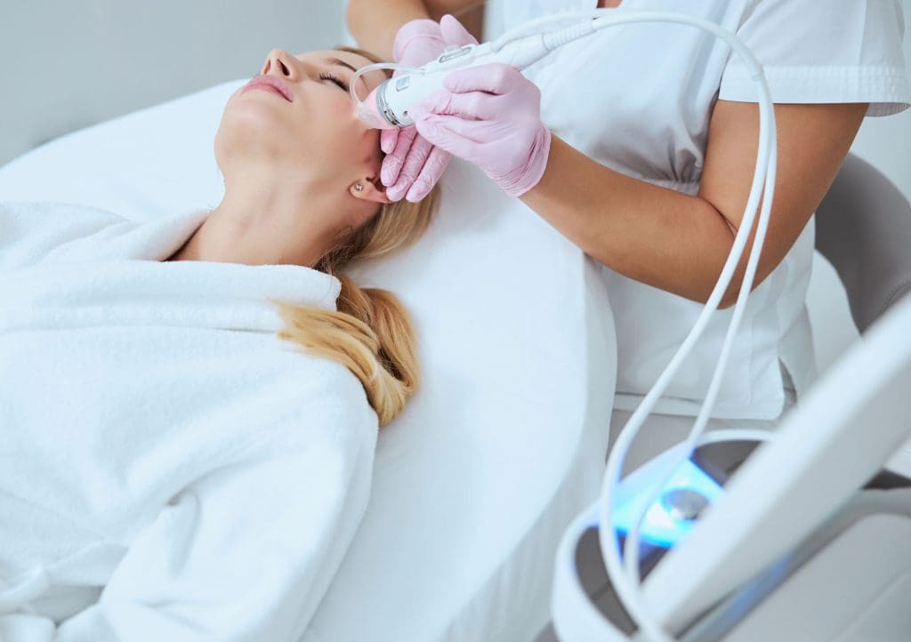 Woman receiving microneedling treatment